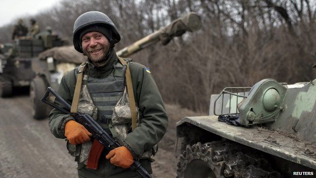A Ukrainian soldier stands in front of cannons in Donetsk region. Photo: 26 February 2015