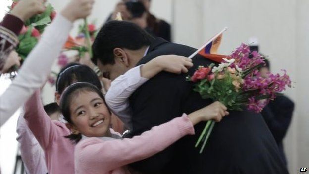 President Nicolas Maduro hugs a child during a welcome ceremony held by Chinese President Xi Jinping at the Great Hal in Beijing on 7 January, 2015.