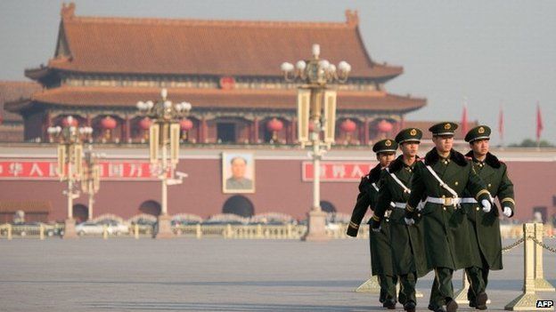 Paramilitary guards walk on a closed-off Tiananmen Square, near the Great Hall of the People prior to the unveiling of a new Politburo Standing Committee, in Beijing on November 15, 2012.