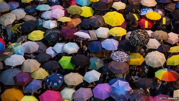 OCTOBER 28: Umbrellas are opened as tens of thousands come to the main protest site one month after the Hong Kong police used tear gas to disperse protesters October 28, 2014 in Hong Kong