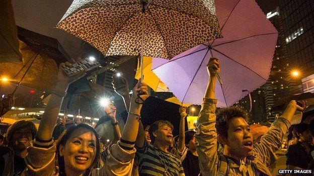 OCTOBER 29: Umbrellas are opened as tens of thousands come to the main protest site one month after the Hong Kong police used tear gas to disperse protesters October 29, 2014 in Hong Kong