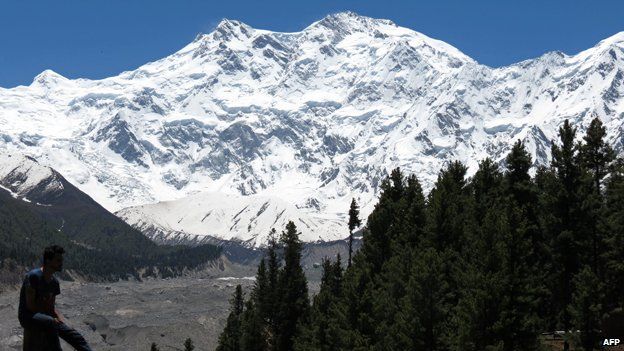 In this photograph taken on August 7, 2014 a sign points towards a view of Nanga Parbat