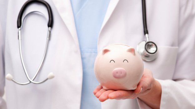 Doctor and piggy bank