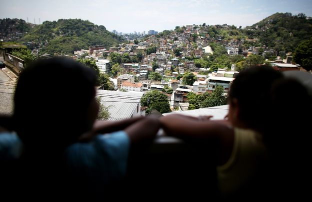 Two girls look out over a favela