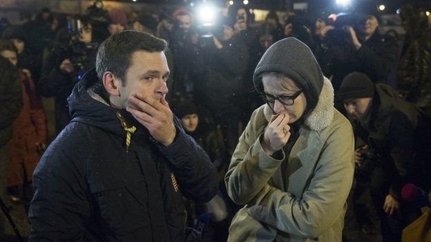 Russian opposition leaders Ilya Yashin, left, and Ksenia Sobchak react to news of the death of Mr Nemtsov - 27 February 2015