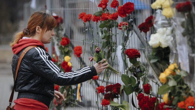 Flowers are left outside the Russian embassy in the Ukrainian capital, Kiev, 28 Feb