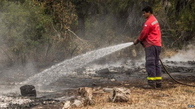 A fireman works in a mountainous zone affected by fire in the province of Chubut, Argentina, 26 February 2015