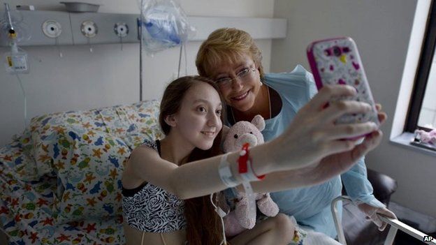 President Michelle Bachelet poses for a selfie with Valentina Maureira at a hospital in Santiago, Chile, 28 Feb 2015