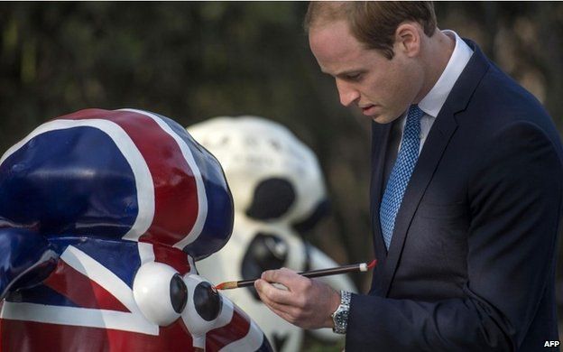 Prince William paints the eye of Shaun the Sheep, from the British animated television series, at the British ambassador's official residence in Beijing