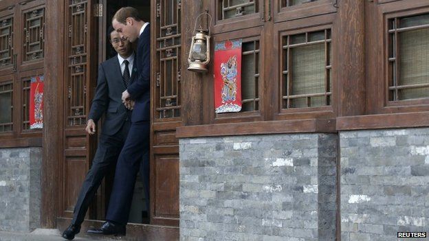 Prince William is guided by Matthew Hu while he visits the Shijia Hutong Museum