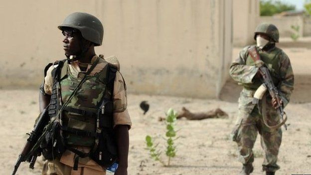 Nigerian soldiers patrol in the north of Borno state close to a Islamist extremist group Boko Haram former camp on 5 June 2013