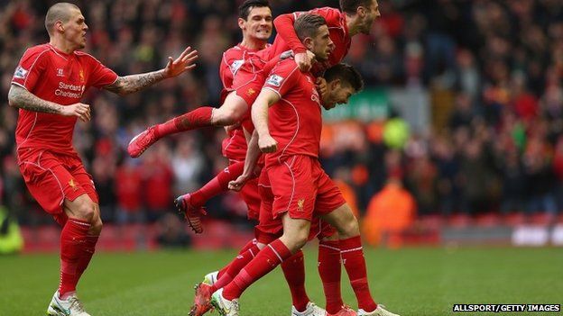 Jordan Henderson (C) of Liverpool celebrates with teammates after scoring the opening goal during the Barclays Premier League match between Liverpool and Manchester City at Anfield