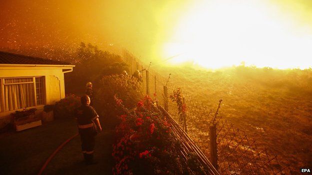 A firefighters tries to stop a blaze in Noordhoek Manor old age home, Cape Town, South Africa, 02 March 2015