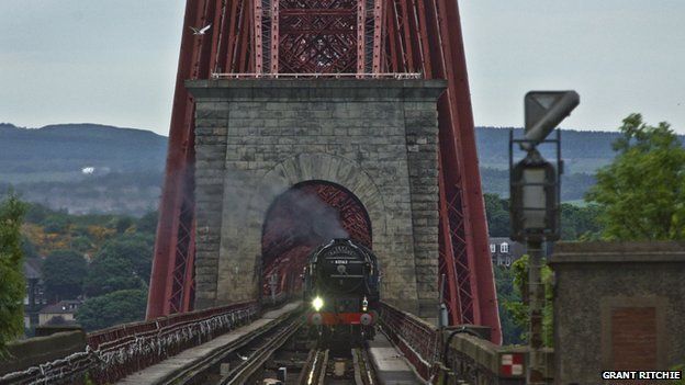 Image shows the Tornado steam train crossing the Forth Bridge on the Fife Circle on Sunday 16th June 2013 taken from the platform at Dalmeny Station.