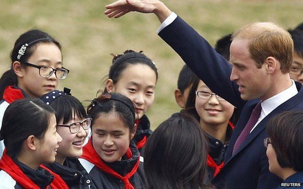 Prince William chats with students during a visit to Nanyang Secondary School