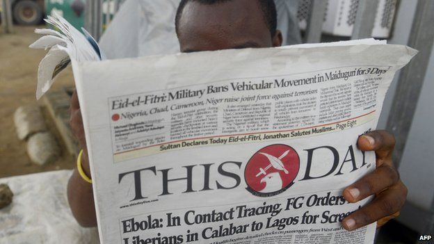 A man reading a ThisDay newspaper in July 2014