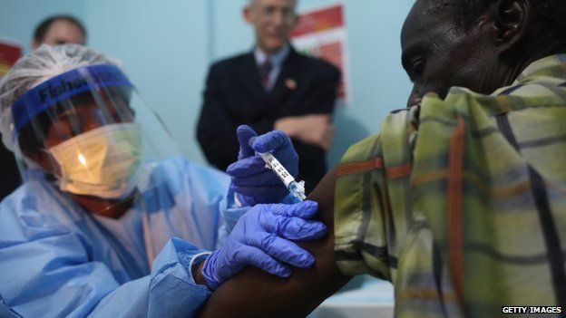 A nurse administers an injection on the first day of an Ebola vaccine study conducted in Monrovia, Liberia ()2 February 2015)