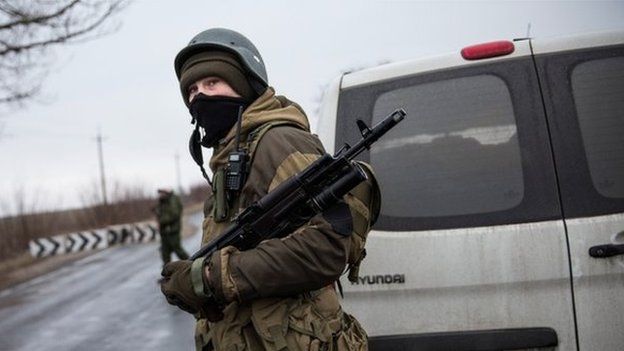 A pro-Russian separatist stands guard at a checkpoint on the road heading to Mariupol on 4 March 2015 in Ukraine
