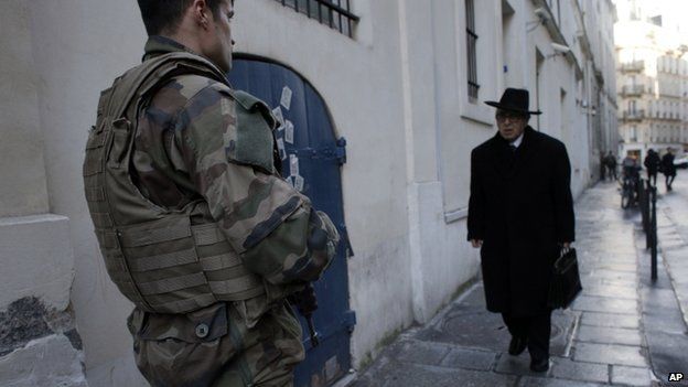Soldiers patrol the street in Paris in January after 10,000 troops were mobilised to protect sensitive sites -nearly half of them to guard Jewish schools