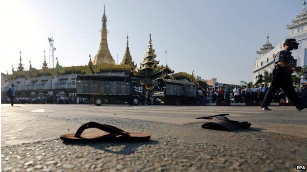 Slippers and headwear belonging to student protesters lie on the street near Suu Lay pagoda after a crackdown