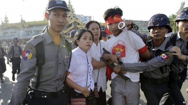 Protesters are detained by police after a gathering opposing a new education law in Yangon