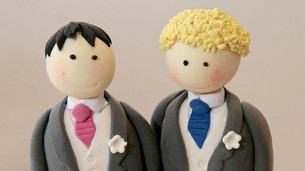 Male figures on top of wedding cake