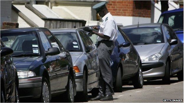 A traffic warden writing a parking ticket