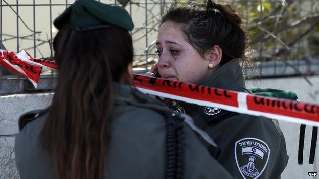 An Israeli policewoman cries near the scene of an attack in Jerusalem