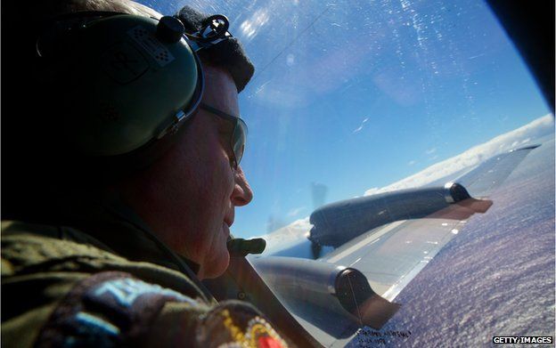 SGT Trent Wyatt, a crew member of a Royal New Zealand Air Force P-3 Orion, on lookout during the search to locate missing Malaysia Airways Flight MH370 at sea over the Indian Ocean on April 11, 2014