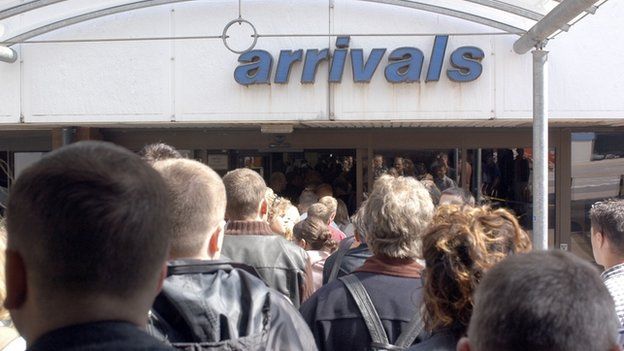 People outside airport arrivals area