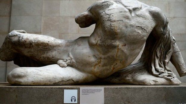 A naked, headless statue, part of a collection of stone objects, inscriptions and sculptures, known as the Elgin Marbles on display in the British Museum