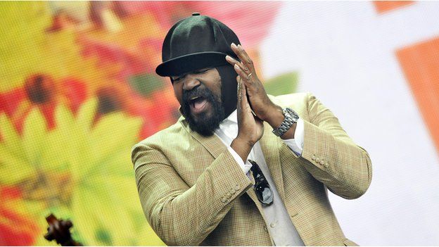 Gregory Porter claps his hands mid-performance