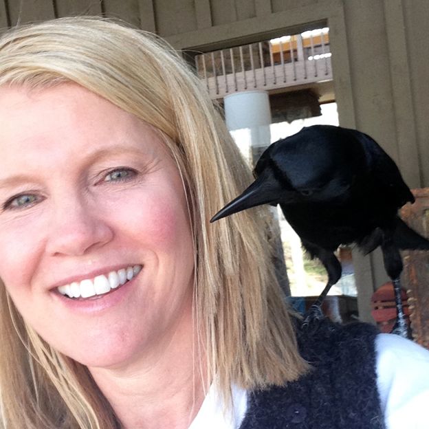 Lynn Witte with crow Sheryl perched on her shoulder