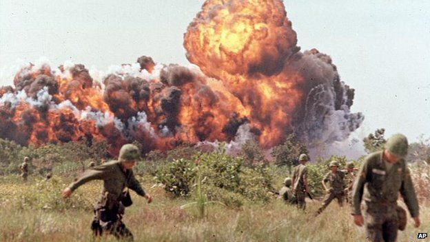 American soldiers run from a napalm attack during the Vietnam War