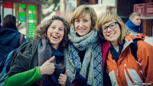 three female tourists smiling