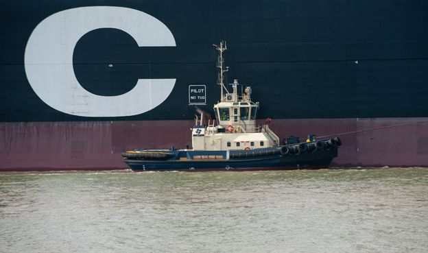 Tug boat alongside letter "C" on MSC Oscar