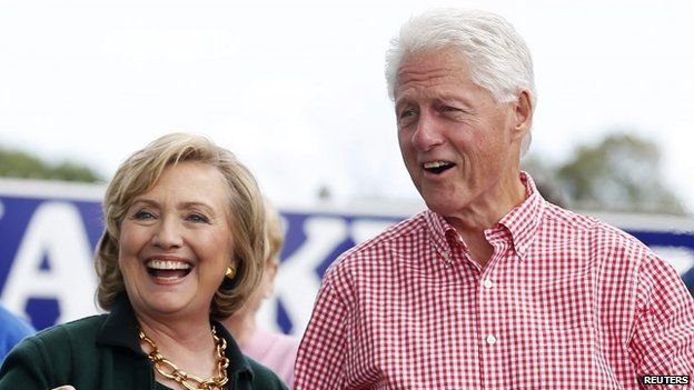 Former U.S. Secretary of State Hillary Clinton and her husband former U.S. President Bill Clinton hold up some steaks at the 37th Harkin Steak Fry in Indianola, Iowa, 14 September 2014