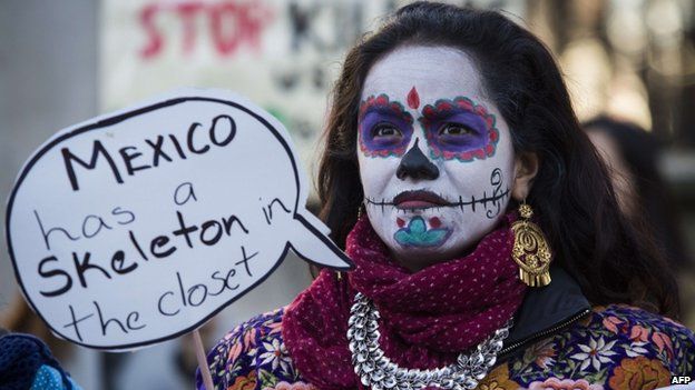 A protester demonstrates outside Downing Street in central London on March 3, 2015 over the abduction of 43 students in Mexico over four months ago, on the first day of Mexican President Enrique Pena Nieto's state visit to Britain