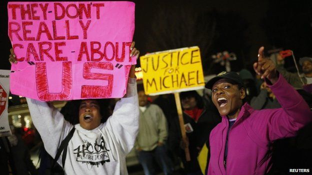 Protestors wave placards in Ferguson, US