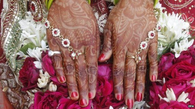 A close-up view of the hands of an Indian bride
