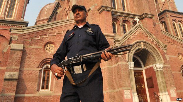 Guard outside Lahore church, 2013