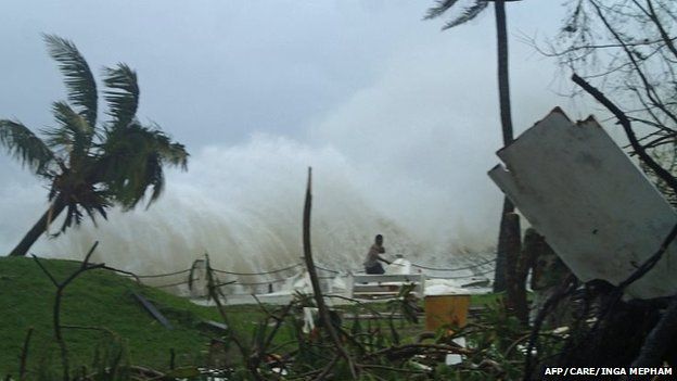 A man runs away form high waves caused by Cyclone Pam along the coast of Vanuatu capital Port Vila (image supplied by Care Australia)