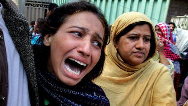 A woman mourns a family member killed in a suicide bombing