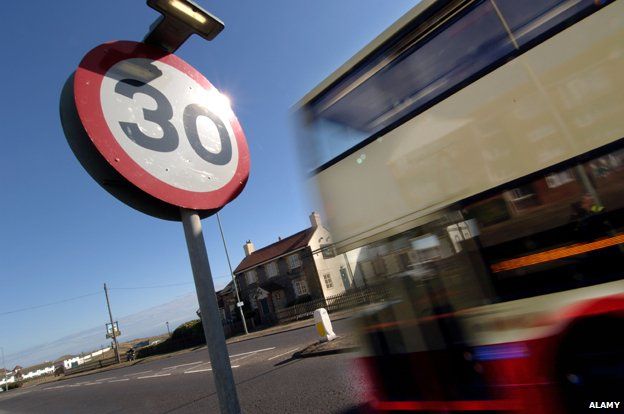 Bus passes 30mph speed limit sign