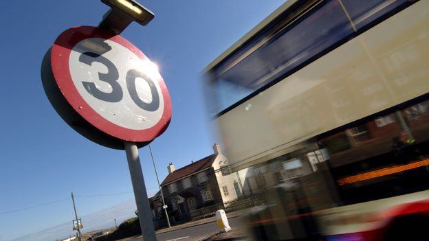 Bus passes 30mph speed limit sign
