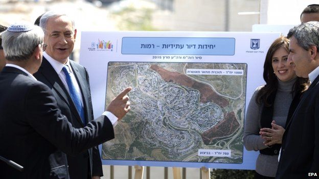 Israeli Prime Minister Benjamin Netanyahu (2-L) looks at future construction plans during a campaign stop at the sprawling south Jerusalem Jewish neighborhood of Har Homa