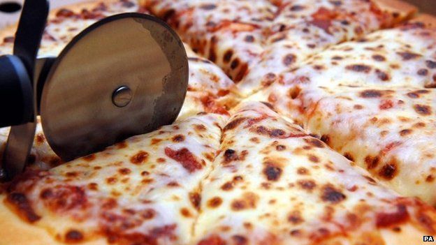 pizza being sliced