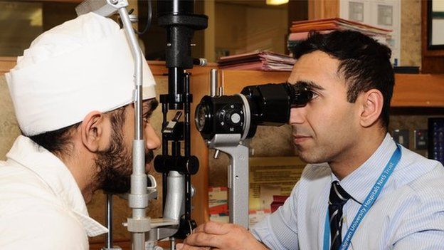 Surgeon Sajjad Ahmad from St Paul's Eye Unit with a patient