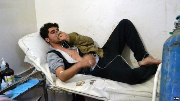 A young man uses an oxygen mask at a clinic after a suspected chorine attack in Sarmin, Idlib province, Syria (17 March 2015)