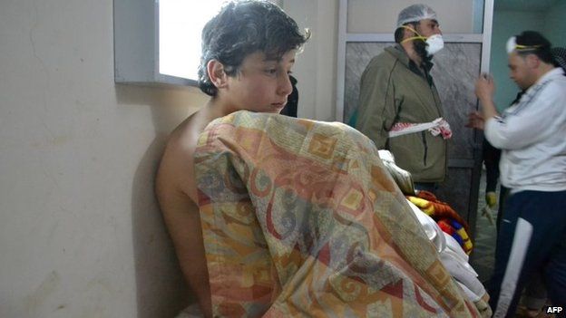 A young Syrian sits on a bed at a clinic after a suspected chorine attack in Sarmin, Idlib province, Syria (17 March 2015)